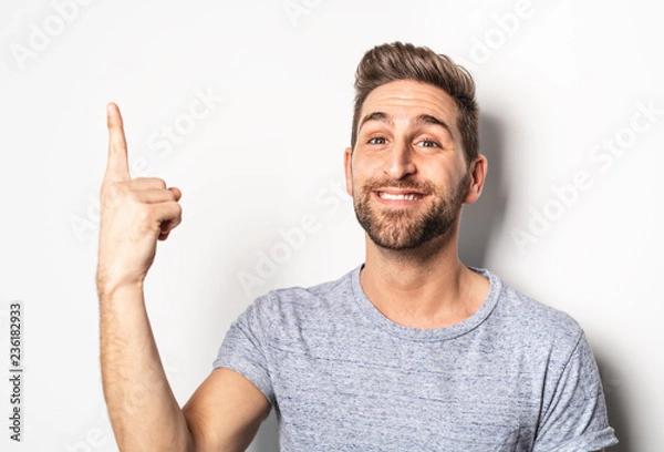 Obraz A nice guy in studio white, pointing something