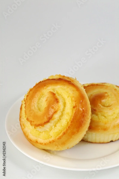 Fototapeta two sweet buns on white plate