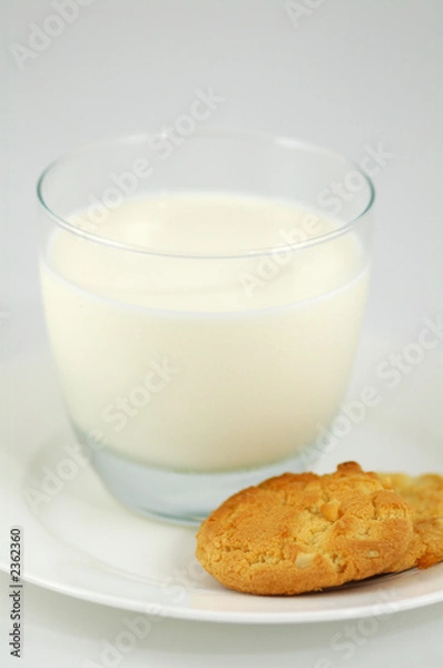 Fototapeta cookies on white plate and glass of milk