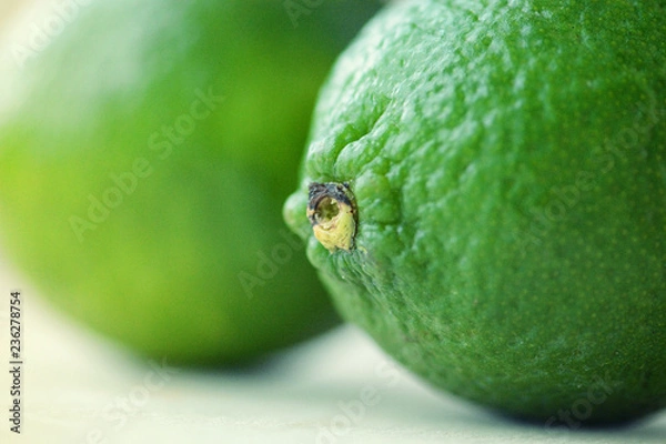 Fototapeta Two bright green limes close-up