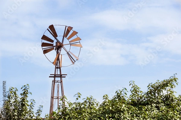 Obraz Vintage toned photo of an old western windmill tower, American wild west symbol .