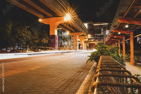 Obraz KUALA LUMPUR, MALAYSIA - NOVEMBER 18 2018 : Night traffic light trail at Bandar Sunway in front of the Sunway City. In conjunction with Artbox 2018 event