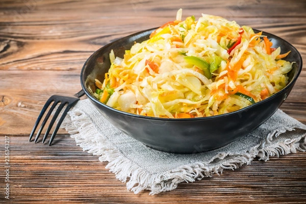 Fototapeta Salad appetizer of fermented vegetables sauerkraut carrots and peppers
