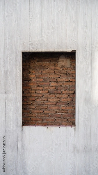 Fototapeta The beautiful sealed brick window in wooden wall for texture background with copy space, may use to interior design