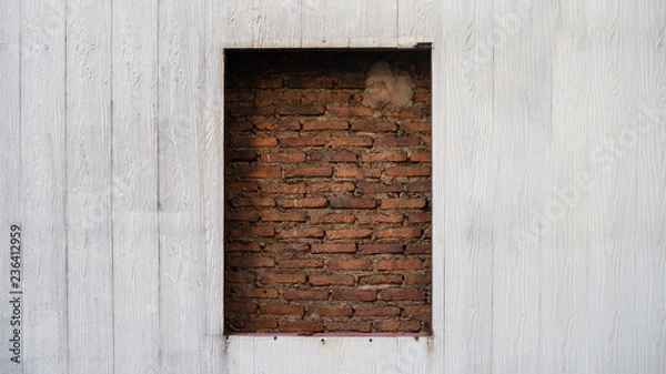 Fototapeta The beautiful sealed brick window in wooden wall for texture background with copy space, may use to interior design