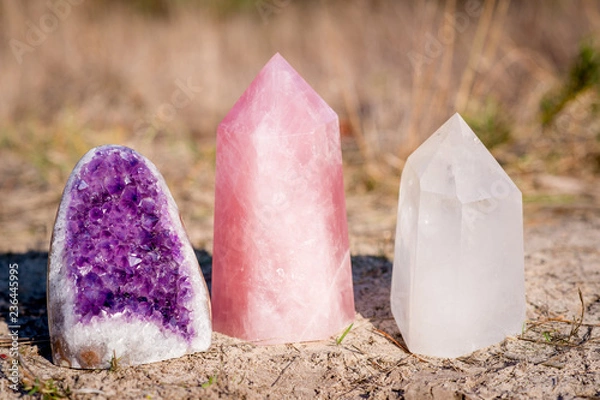 Obraz Golden Triangle gemstones: amethyst, rose quartz and white quartz, standing together in the grass