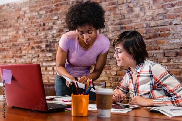 Fototapeta Boss and employee working on business proposal at office