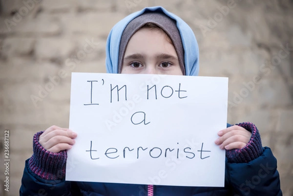 Obraz Portrait of refugee with text on paper standing outdoors