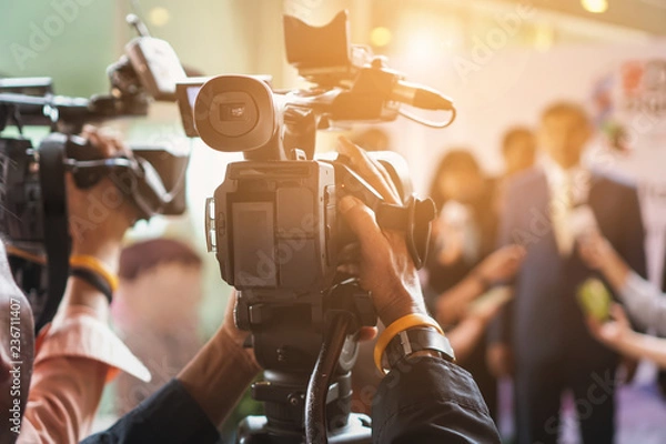 Fototapeta cameraman recording. videotaping microphone journalist journalist interviewing. live streaming concept.