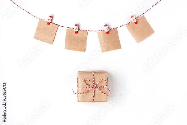 Fototapeta Gift, candles, notes with wish on clothespins, Top view White Background Christmas New Year