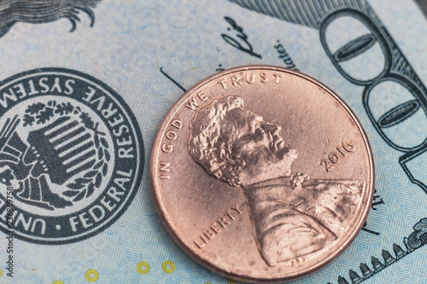 Fototapeta Macro photo of one cent and 100 US dollars on the background. Obverse american coin 2016 face value 1 cent photographed very close.