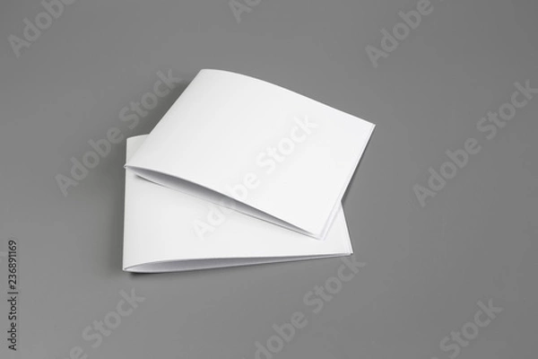 Fototapeta Blank portrait mock-up paper. brochure magazine isolated on gray, changeable background / white paper isolated on gray