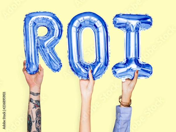 Obraz Hands holding ROI word in balloon letters
