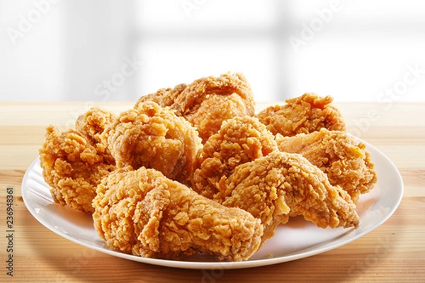 Fototapeta crispy coated batter southern style fried chicken in a wooden table