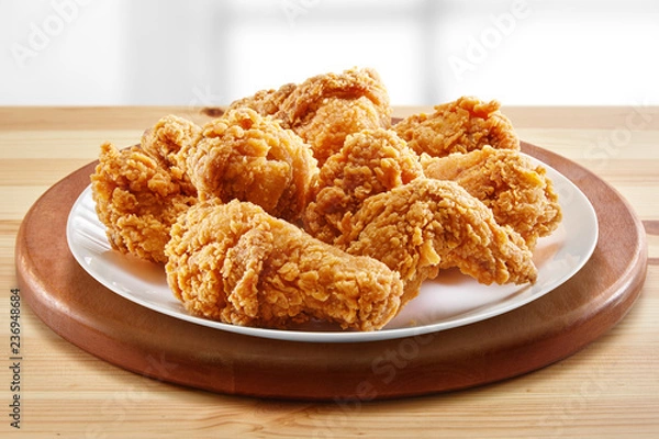 Fototapeta crispy coated batter southern style fried chicken in a wooden table