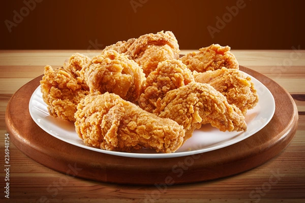 Fototapeta crispy coated batter southern style fried chicken in a wooden table