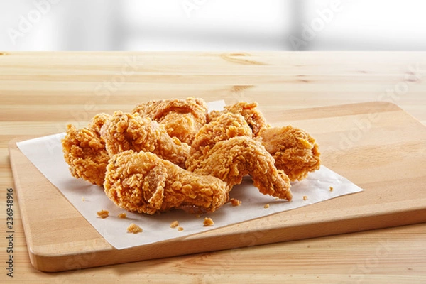 Fototapeta crispy coated batter southern style fried chicken in a wooden table
