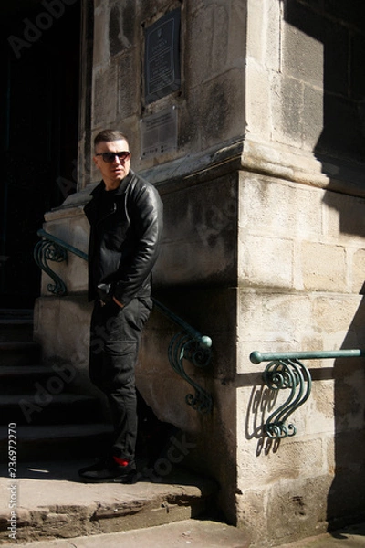 Obraz man in sunglasses on the background of architecture