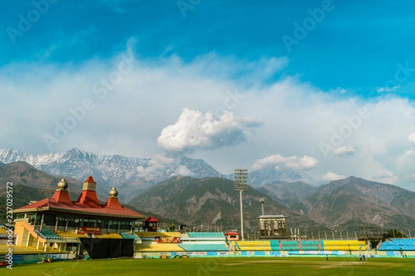 Obraz World's highest altitude international cricket stadium, HpCA Cricket Stadium with Dhauladhar Range surrounding it. Kangra Valley
