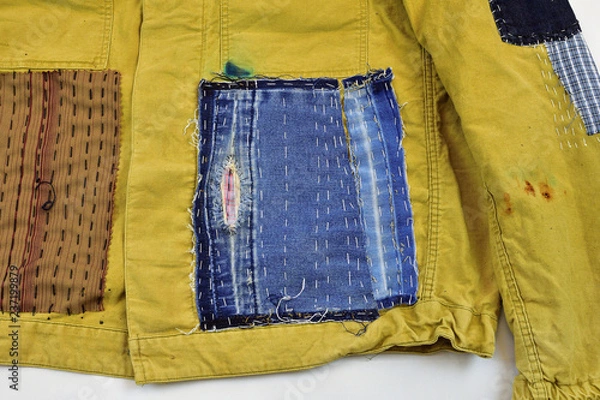 Obraz Khaki vintage jacket with patchwork decor sashiko detail, on a white background