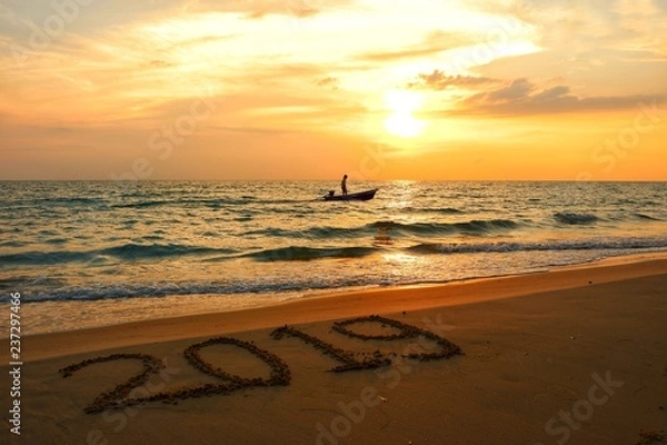 Fototapeta Happy new year concept, 2019 put on sand beach in sunset.