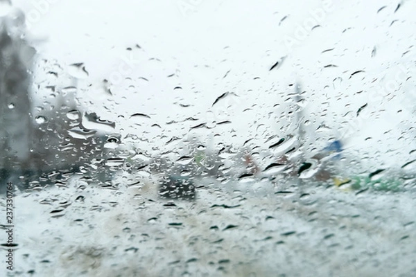 Fototapeta Drops from the rain on the glass of the car as a background