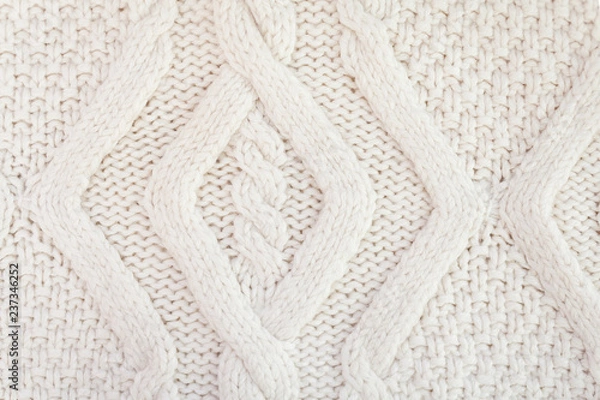 Fototapeta Knitted white fabric texture with a relief pattern. Warm winter clothes or blanket. Handmade texture