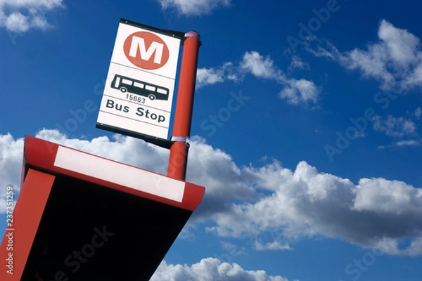 Fototapeta BUS SHELTER AND BUS STOP SIGN WITH BLUE SKY BACKGROUND