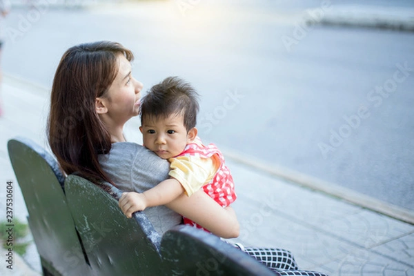 Fototapeta The mother carries the child in her arms