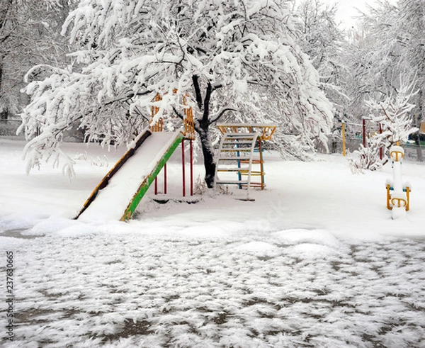 Obraz Snow-covered attractions in the old park