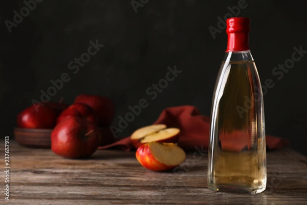 Fototapeta Composition with bottle of apple vinegar on table. Space for text