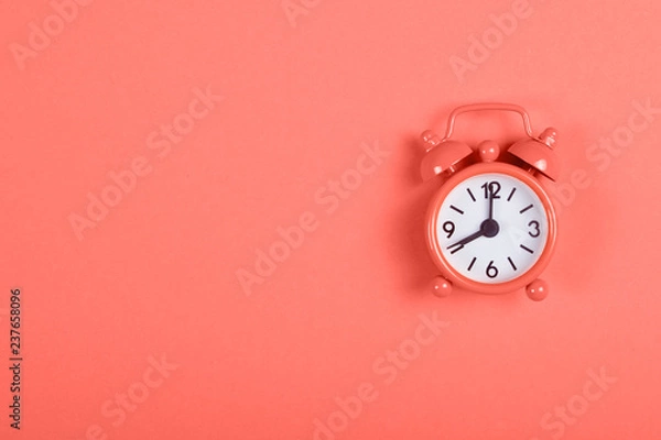 Obraz Alarm clock on coral background.