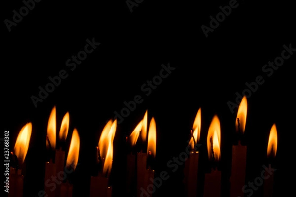 Fototapeta Candle flame set isolated in black background.