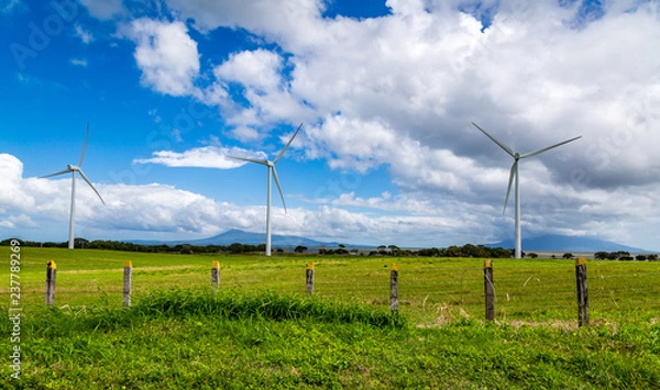 Fototapeta Wind Farm with a view of the valley and mountains beyond