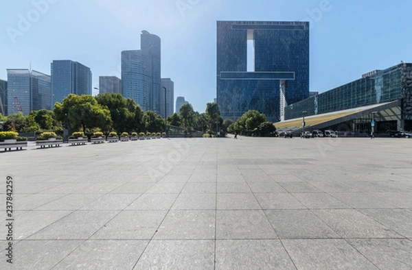 Fototapeta Panoramic skyline and buildings with empty concrete square floor，Qianjiang New Town，hangzhou,china