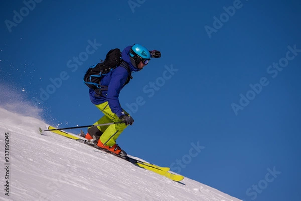 Fototapeta Skier having fun while running downhill