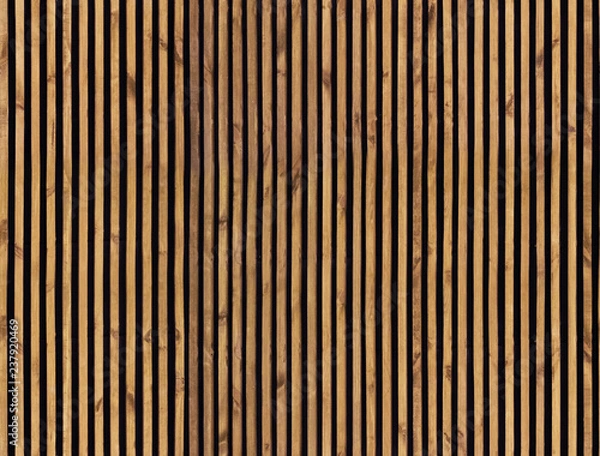 Fototapeta Jednolity wzór nowoczesnych paneli ściennych z pionowymi listwami drewnianymi na tle. Surowiec z naturalnej brązowej listwy drewnianej.