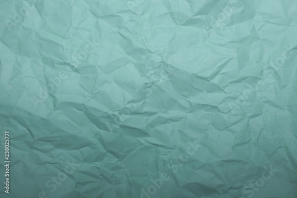 Fototapeta Light green crumpled sheet of paper close up, background image