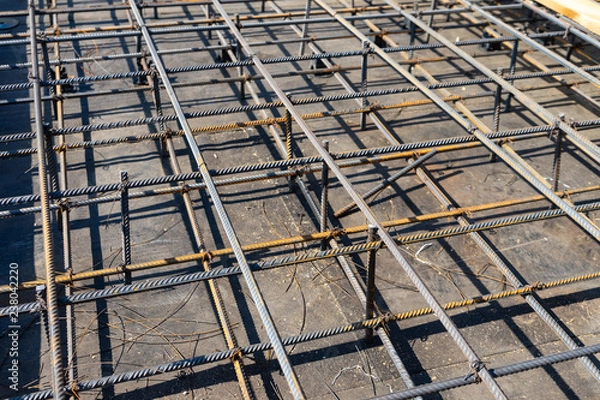 Obraz Tie rebar beam cage on construction site. Steel reinforcing bar for reinforced concrete.