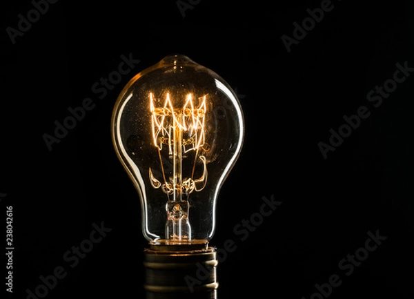 Obraz Edison's light bulb illuminates from electric current