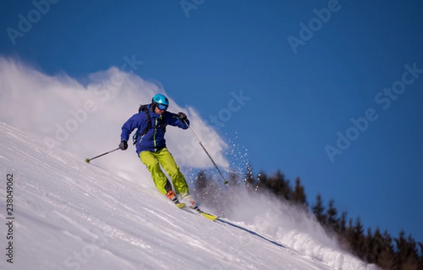 Fototapeta Skier having fun while running downhill