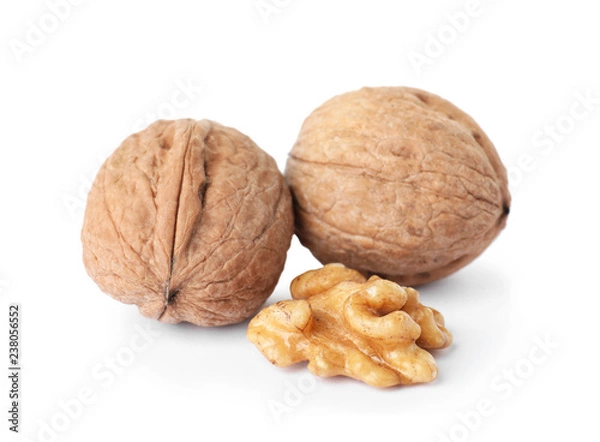 Fototapeta Walnuts in shell and kernel on white background. Organic snack