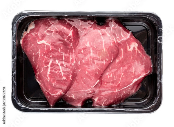 Fototapeta Vacuum-packed beef on a white background. Marbled beef from the store isolated on a white background.