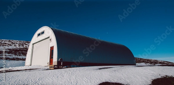 Fototapeta Warehouse road maintenance material on top of a snowy mountain.