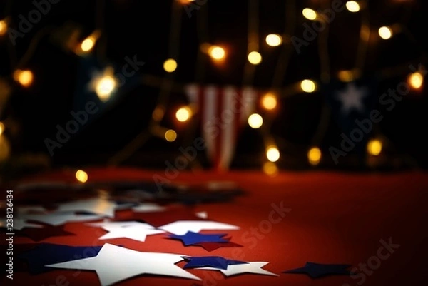Fototapeta Fireworks display celebrates the independence Day of the United States of America nation on the fourth of July with the us flag , sparklers , candy, on the red background and on the background of
