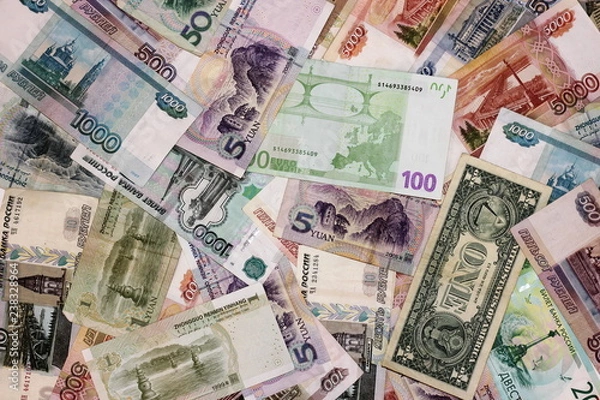 Obraz Much money. Banknotes of different countries are a bunch of alternately. Rubles, dollar, Euro, yuan. The concept of international business and tourism.