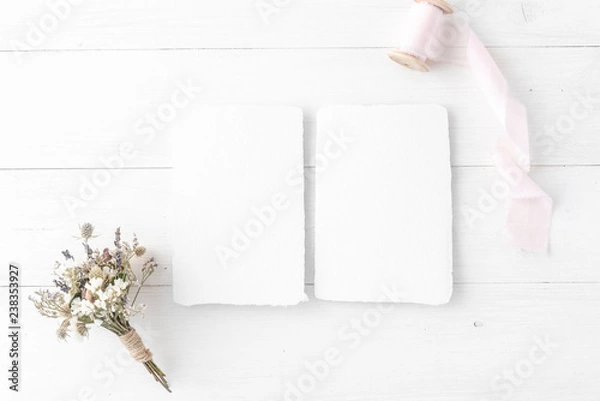 Fototapeta Feminine wedding, birthday desktop mock-up. Invitation card mockup, template Blank greeting cards, rspv card, 5x7, card, envelope. Silk ribbons, pink, dry flowers. White wooden background. Flat lay