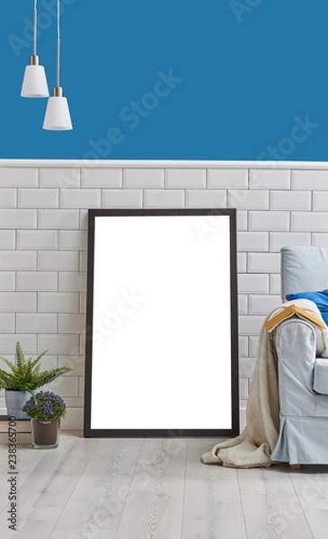 Fototapeta Frame and picture in the room with blue armchair lamp and vase of plant, book style. White ceramic and blue wall background.