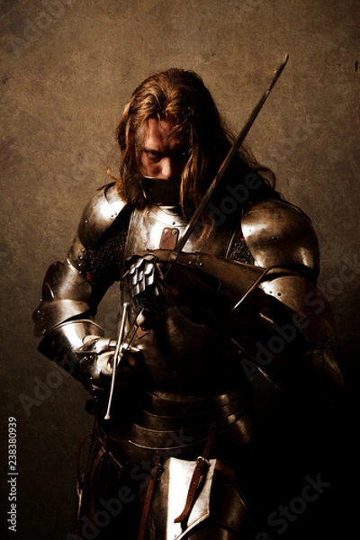 Fototapeta Portrait of a knight in armor in attack position