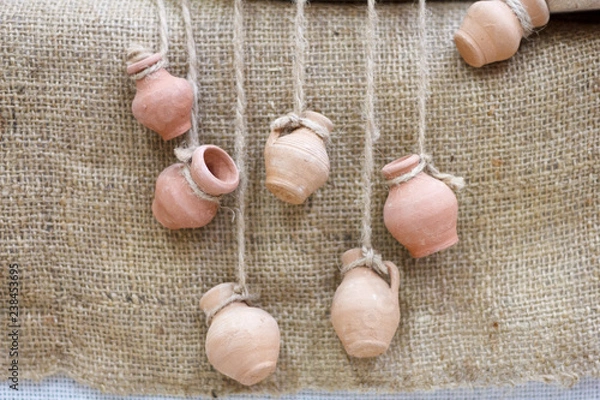 Fototapeta Small jars on a string